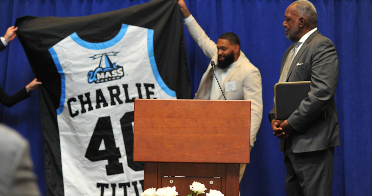 Charlie Titus and the unveiled banner with his retired number 40 