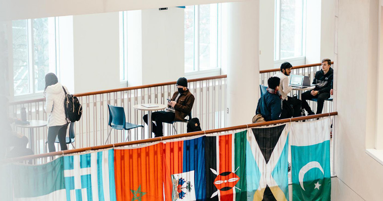 Students in the Campus Center with flags 