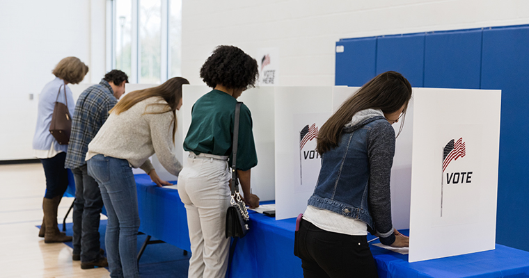 People at the polls, casting votes 