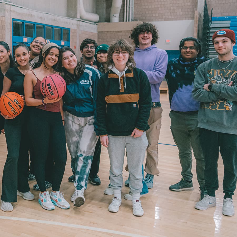 Group of students pose with basketball.