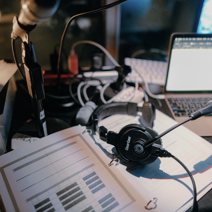 Microphone, laptop, headset, and textbook