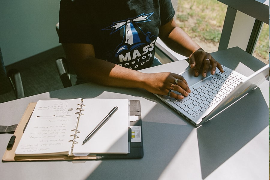 Student on a laptop taking notes