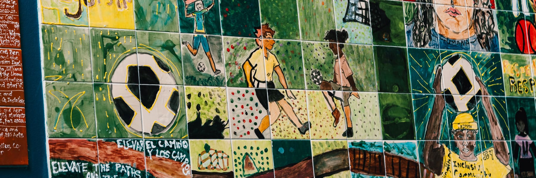 Mural of young people playing soccer in Boston.