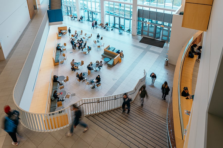 top view of students sitting casually at tables in UMass Boston University Hall