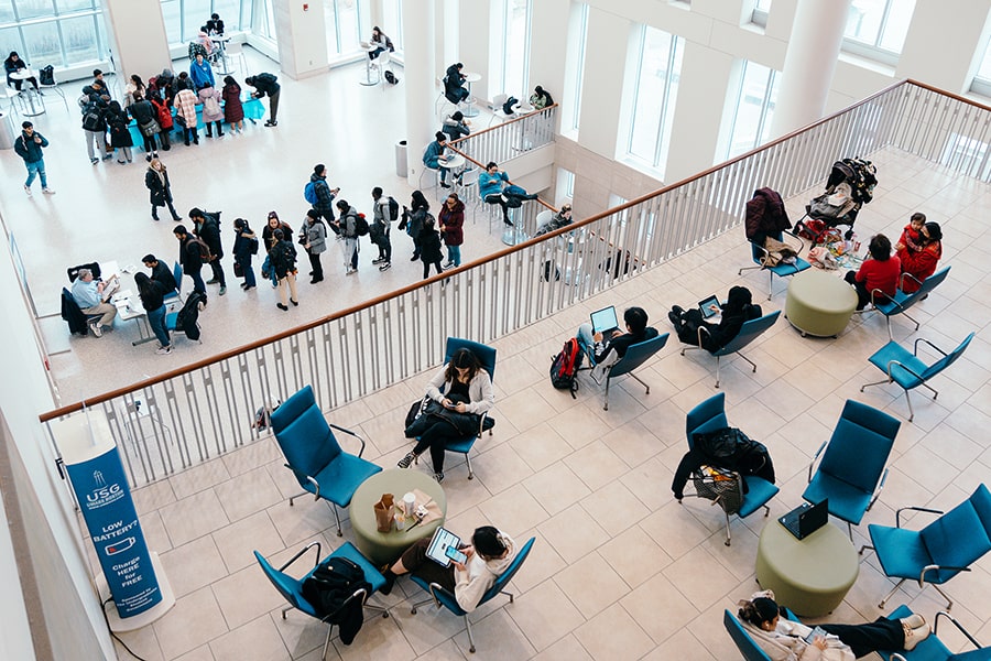 top view of students sitting casually at tables in UMass Boston Campus Center