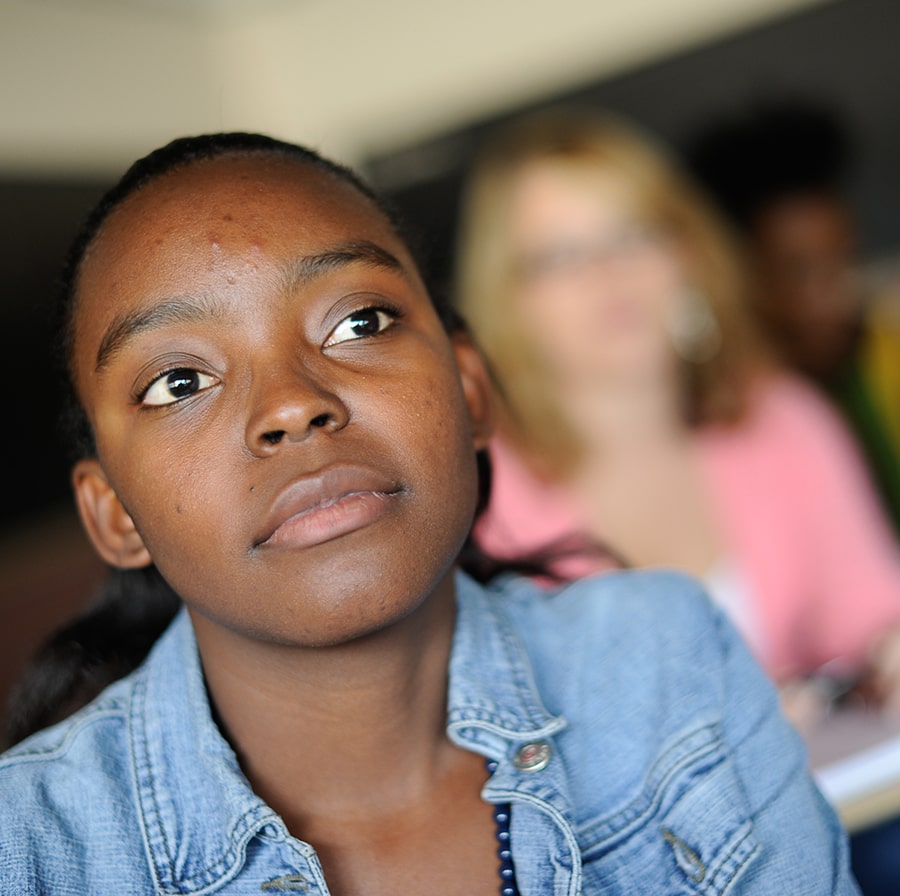 up close image of student in class with another student in background blurred