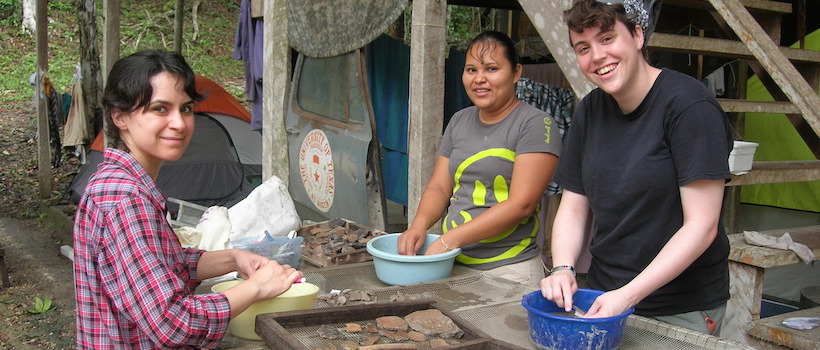 Field school students in Belize washing artifacts.