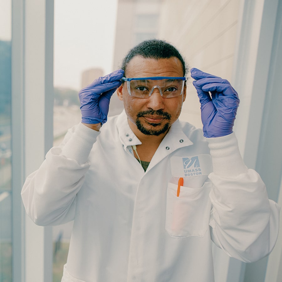 Grad student with goggles and labcoat poses in  ISC