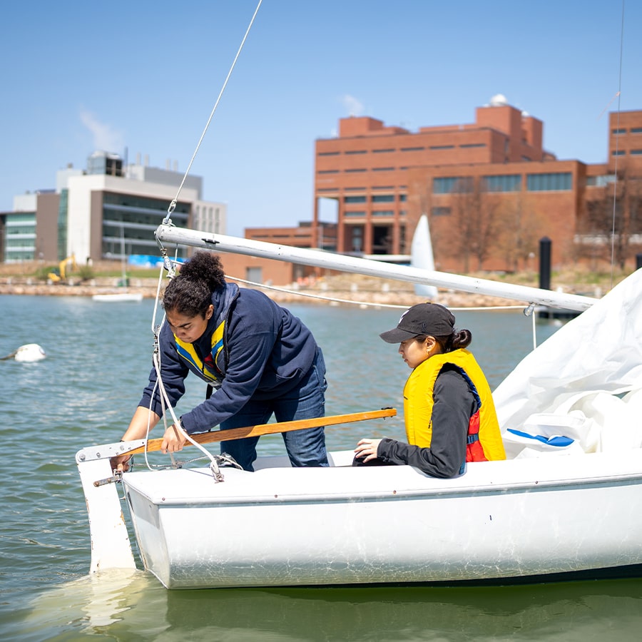 Students sailing in Savin Hill Cove next to UMass Boston.