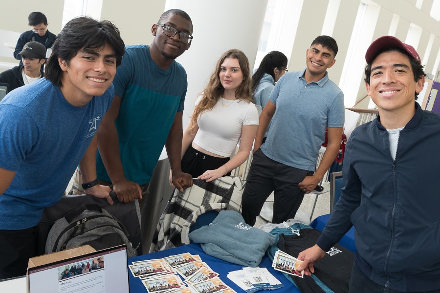 Group of students at clubs tabling event in campus center.