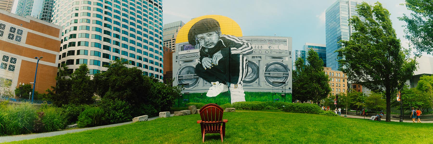 ProBlak mural of person in front of boombox on building on Boston Greenway.