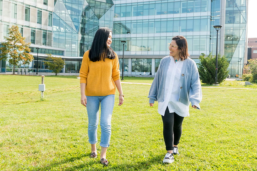 Students walking in front of the Integrative Sciences Complex at UMass Boston.