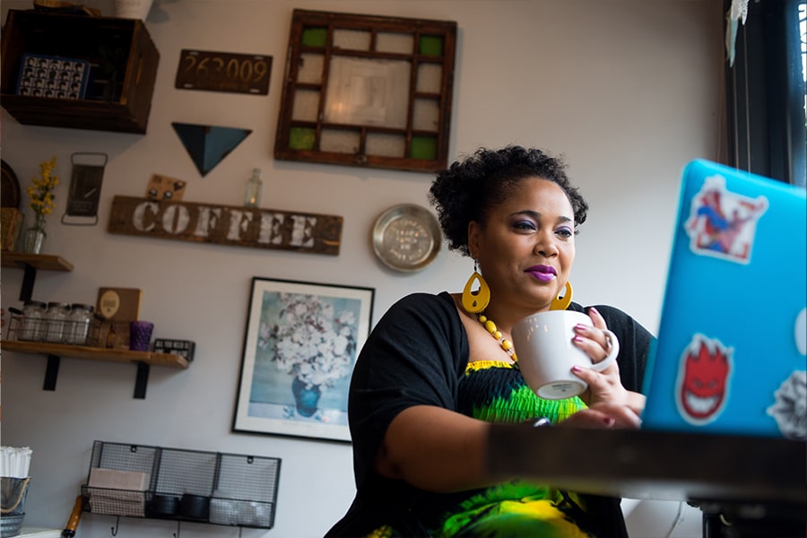 Student works on laptop at the Honeycomb Cafe in Dorchester.