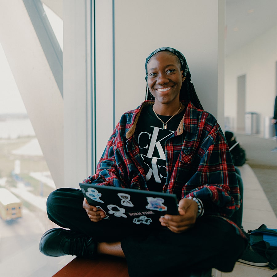 Student with Laptop in campus center.