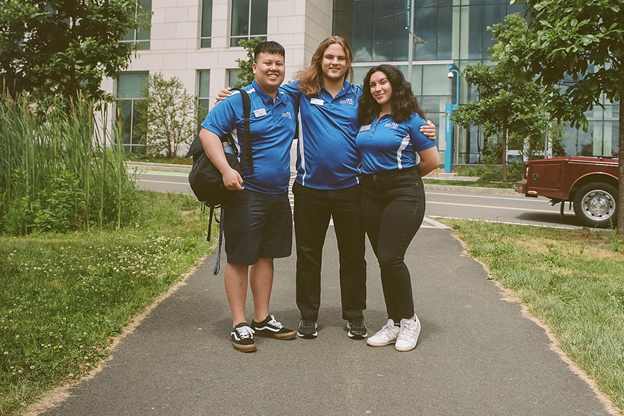 3 Students in UMB orientation shirts ready to lead.