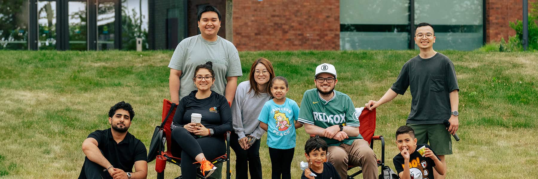 Family hanging out together at UMass Boston Field Day