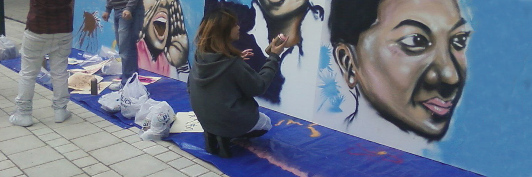 young asian people painting mural