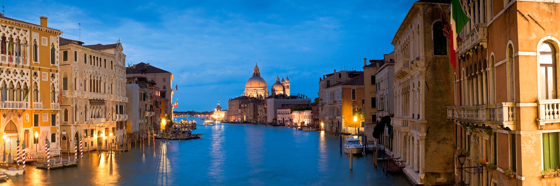 Large detailed panoramic view of the Grand Canal in Venice the stunning baroque Santa Maria Della Salute (1687) church in Venice and colorful villas illuminated by venetian lamps