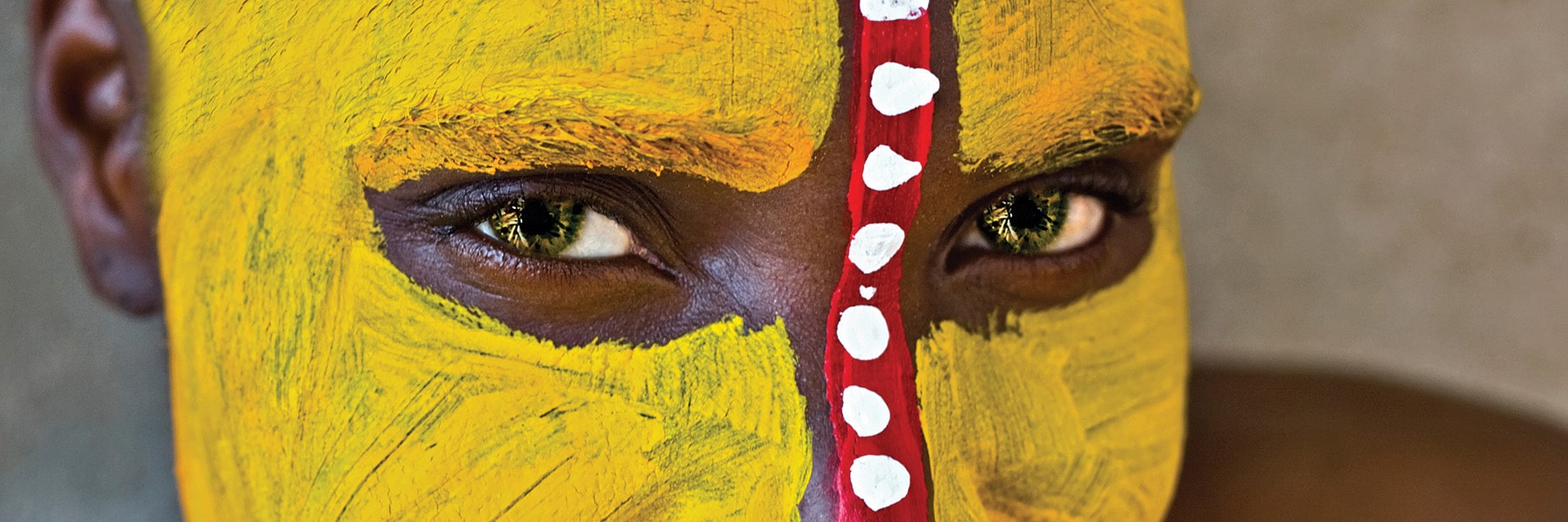 Closeup of a African tribe member's face with traditional paint