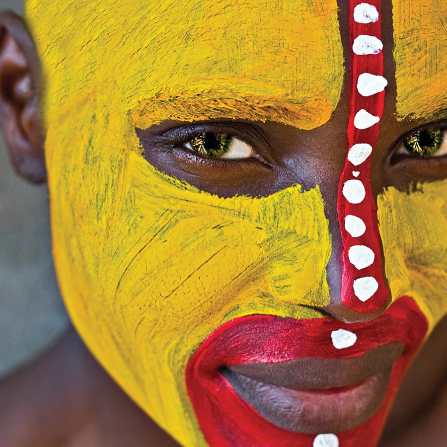 African person with tribal paint on face.