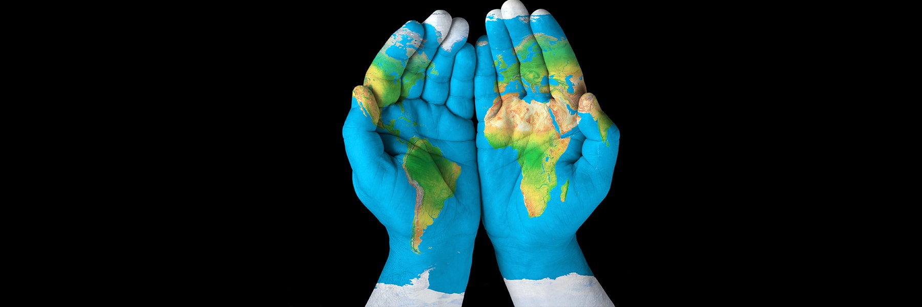 Hands with map of world superimposed on them.