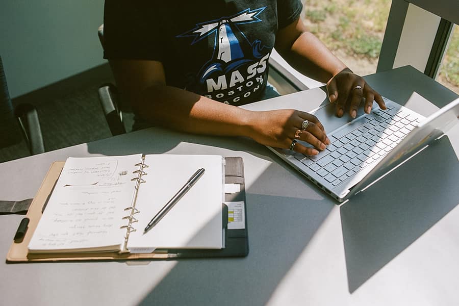 Student types on laptop.