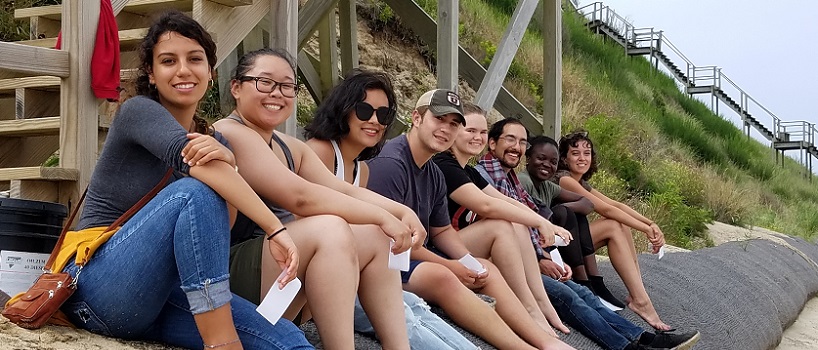 Nantucket Field Station students sitting on a beach armament.