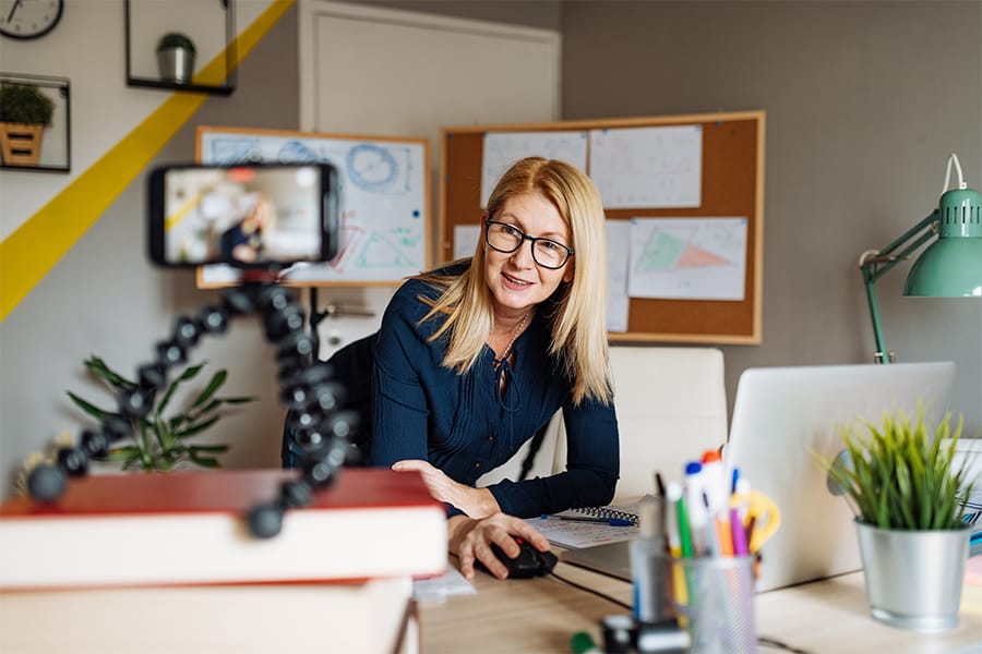 Woman looks at camera while working from her home office.