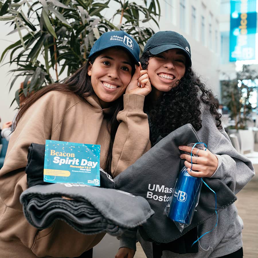Students showcasing UMass Boston marketing swag