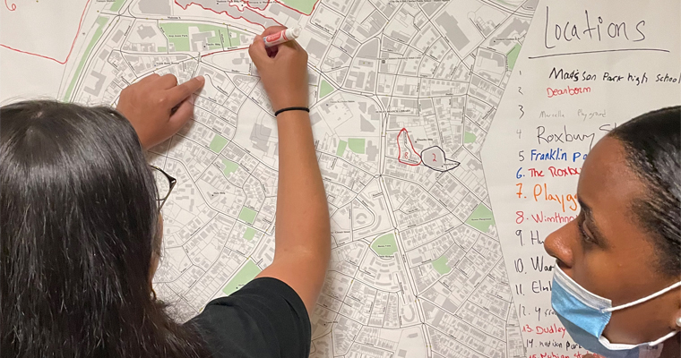 Two students work with a map. 