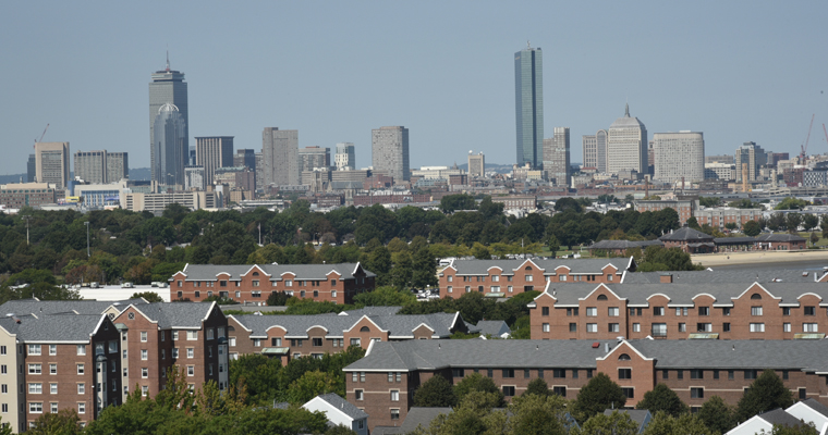 Boston skyline, with homes in the foreground 