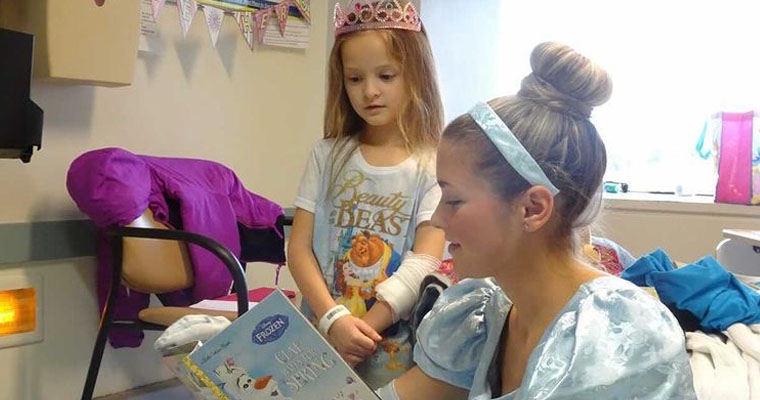 Cinderella reads to a sick patient.