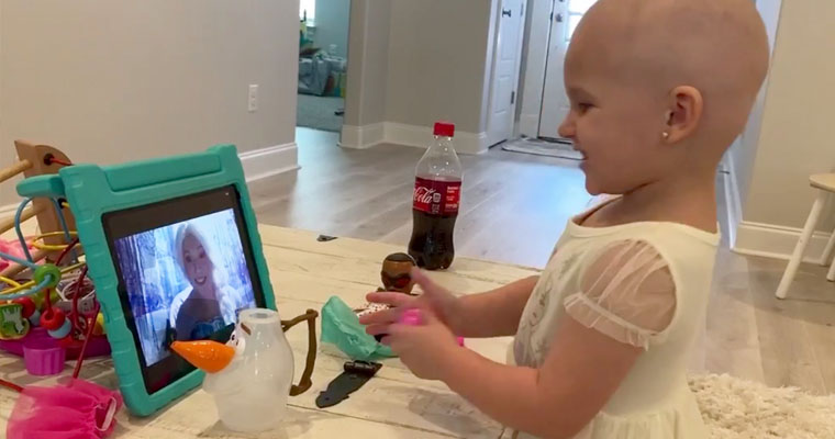 A sick child participates on a Zoom call with Princess Elsa. 