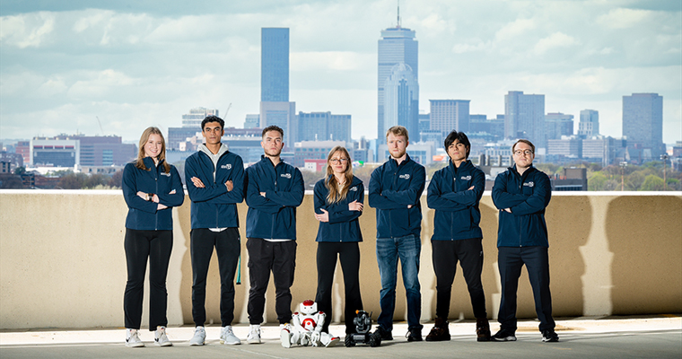 Robotics Team with Boston skyline behind them 