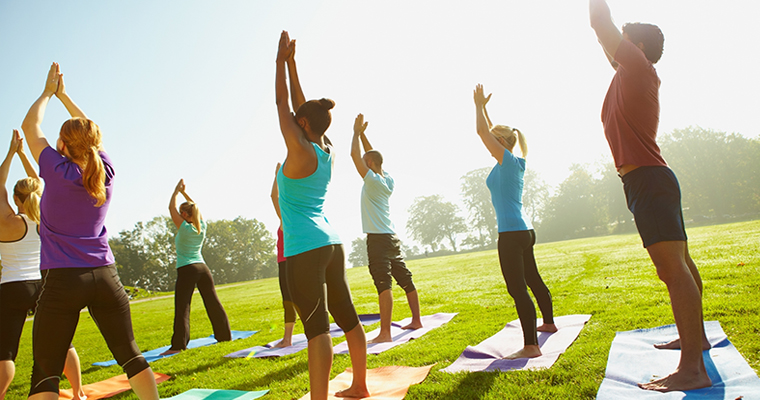 People doing yoga outdoors 