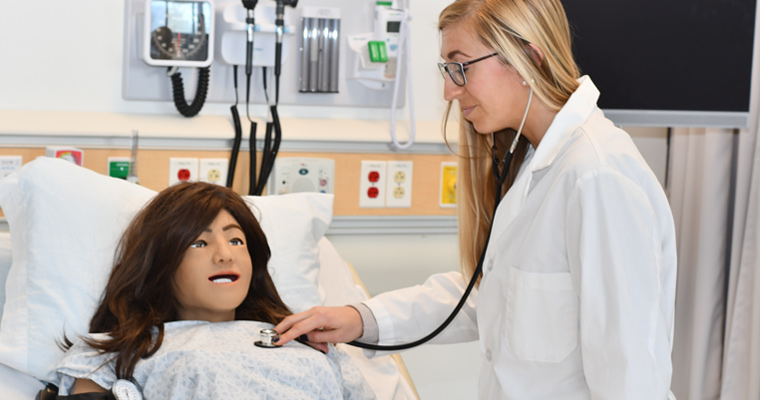 Nursing graduate student with a mannequin in the CCER 