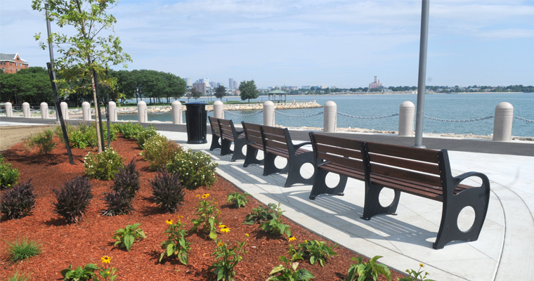 A portion of UMass Boston's HarborWalk, where there are currently benches and plantings 
