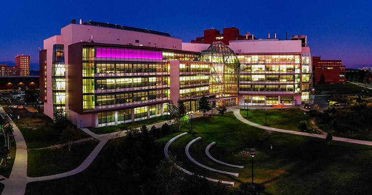 The Integrated Sciences Complex, lit up at night 