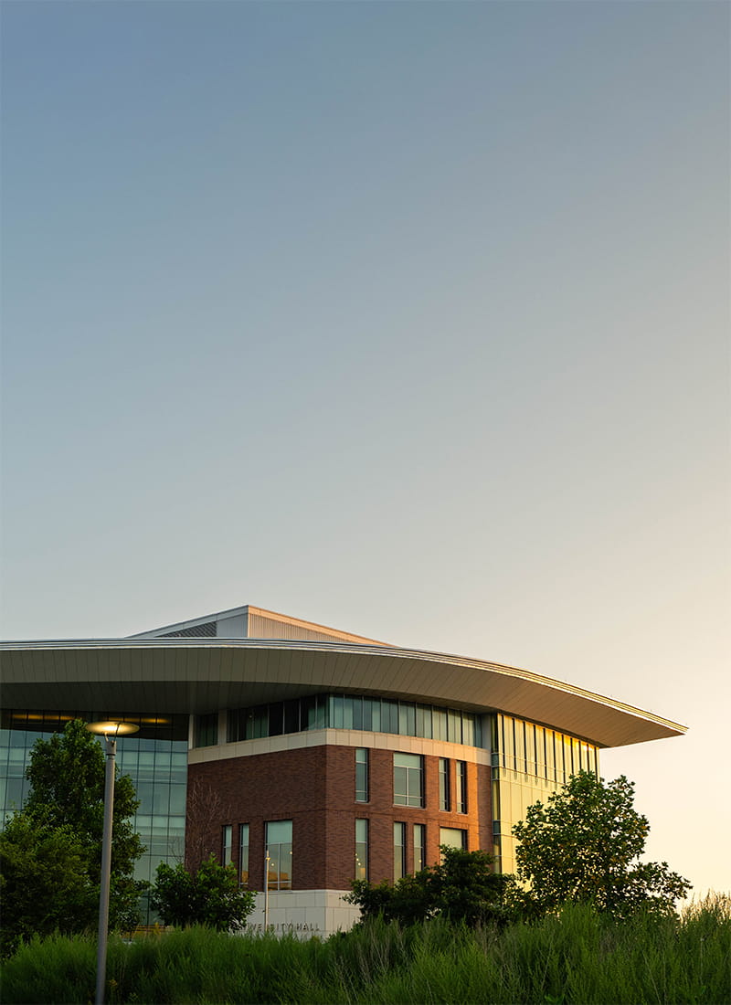 UMass Boston Integrated Sciences Complex building reflecting the sunrise.