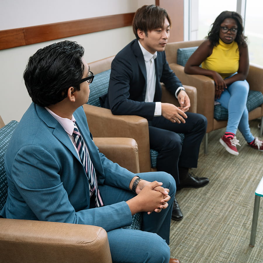 college of management students conferring casual setting