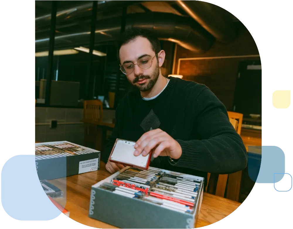 Student looking through historic tapes.
