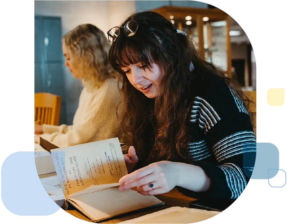 Students looking through early editions of novels.