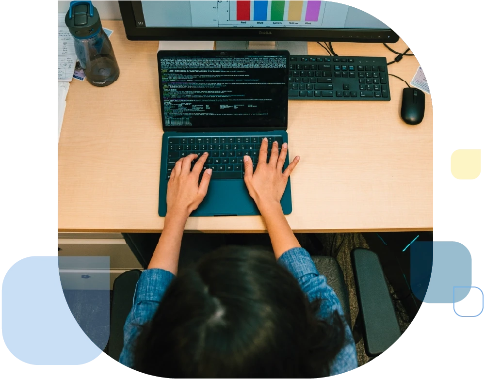 Student coding and working on laptop.