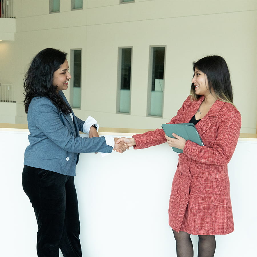 Students shaking hands with one another.
