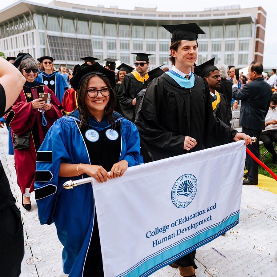 education students holding banner during Commencement
