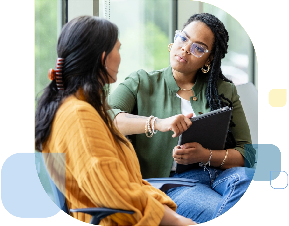 female counselor listens with empathetic facial expression as a vulnerable patient shares about a difficult situation.