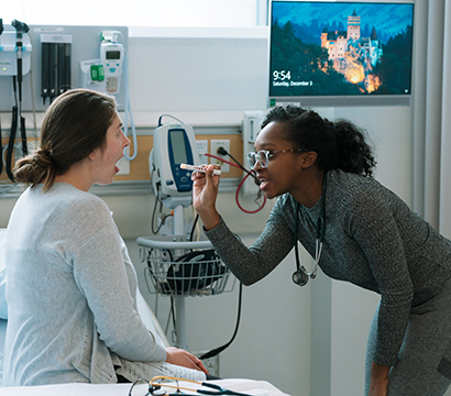 Two nursing students work together in a nursing lab class