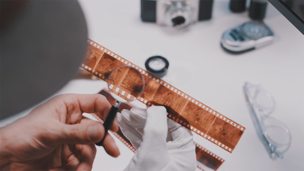 Student examining historic film strip.