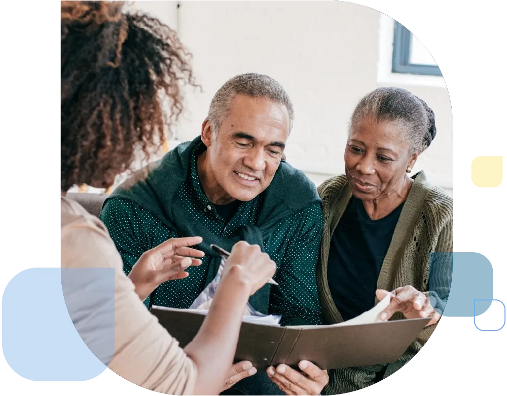 Elderly couple consulting with care planner.