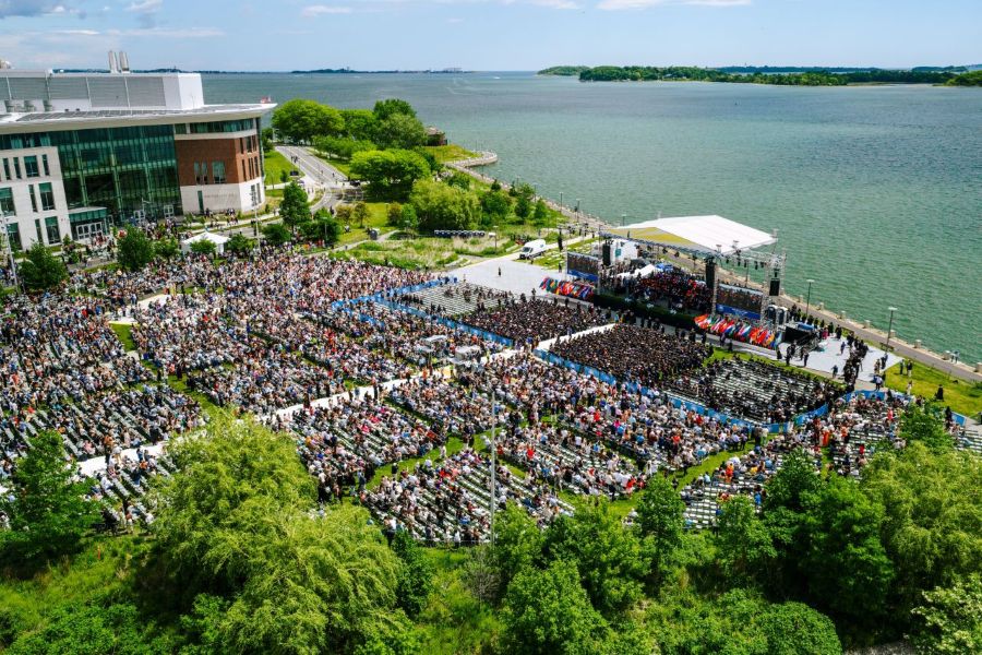 Aerial of the commencement ceremony showing stage and ocean